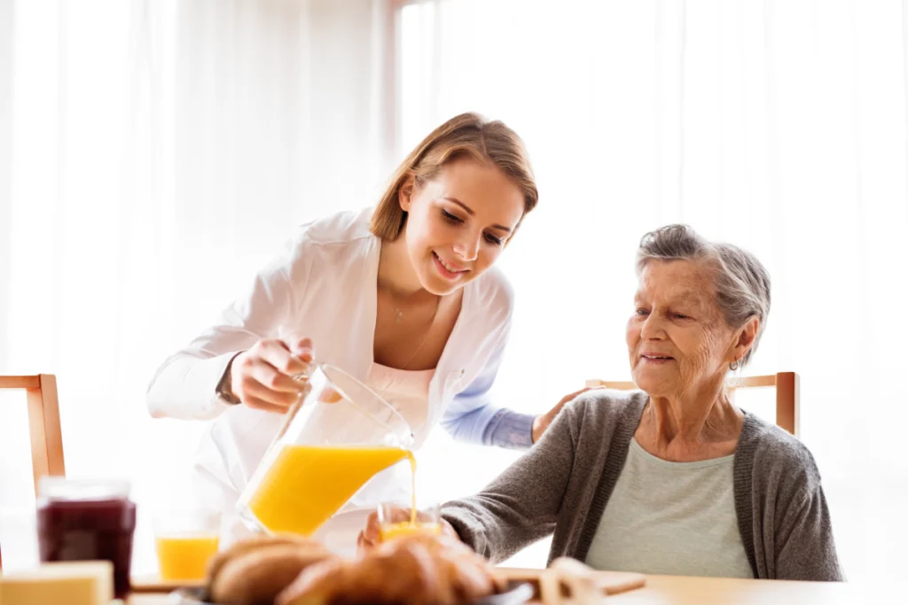 A team member pouring a drink for a resident