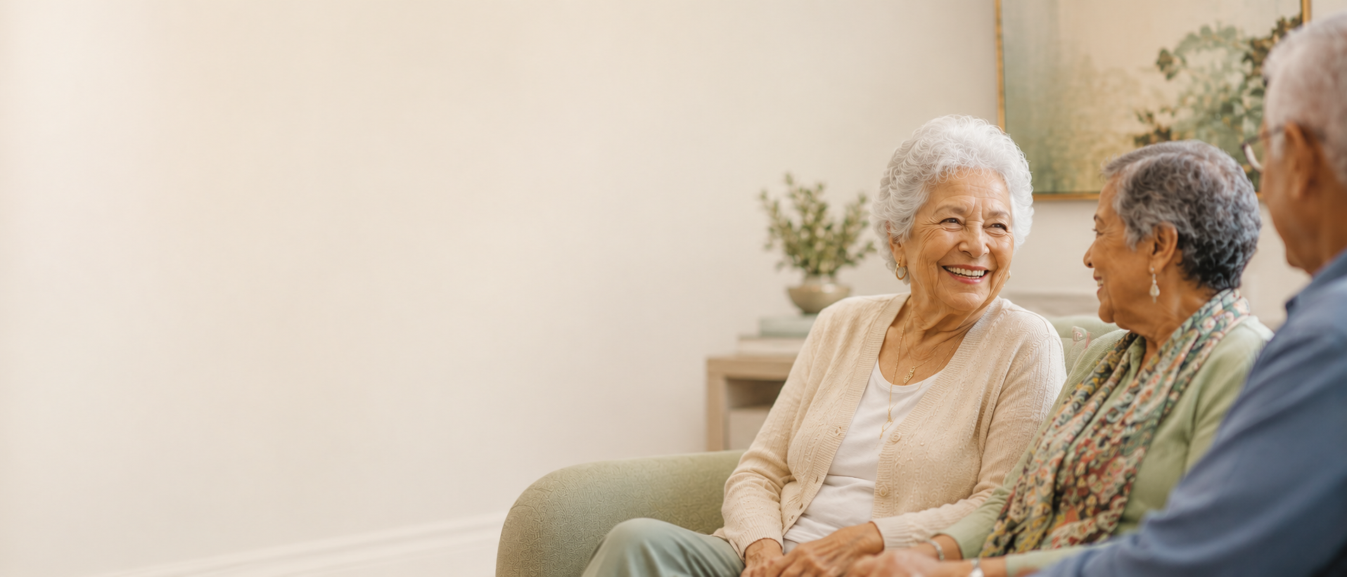 Two residents talking together on a couch in a common room